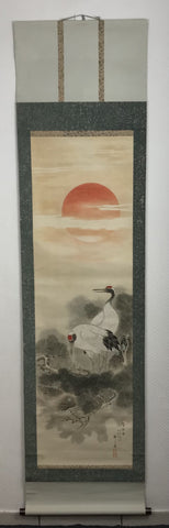 Cranes with pine and sun